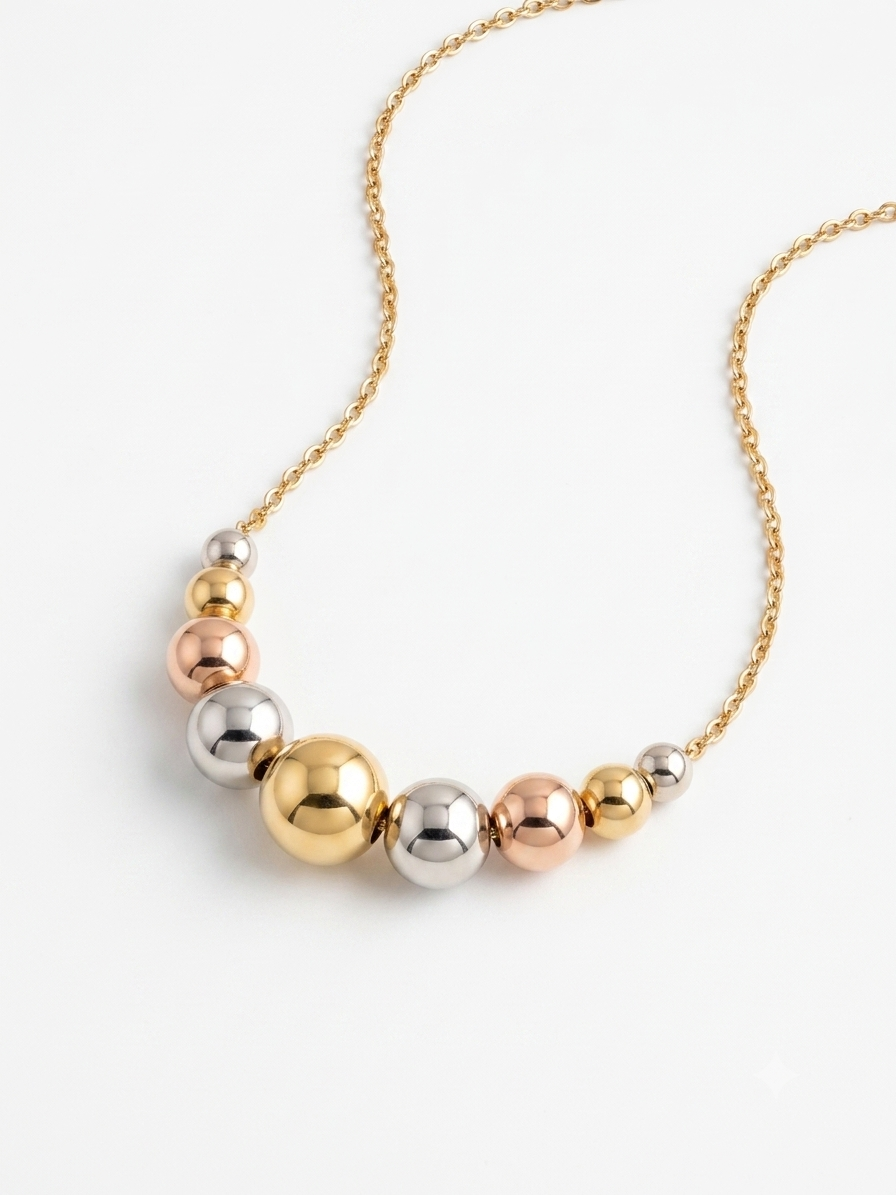 Italian 18K tri-color gold graduated bead necklace by Almas Jewellery Vienna, featuring multi-tone gold beads on a delicate chain.